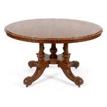 A Victorian mahogany centre table, the tilt top on four fluted and carved columns with four