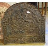 A cast iron fire back, decorated a chariot scene within a foliate border, 55 cm wide