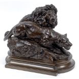 A bronze group of a lion and a lioness, on a rocky mound, indistinctly signed, 29 cm high See