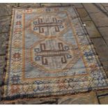 A 20th century carpet, decorated geometric motifs on a beige ground, within a multi-border, 188 x