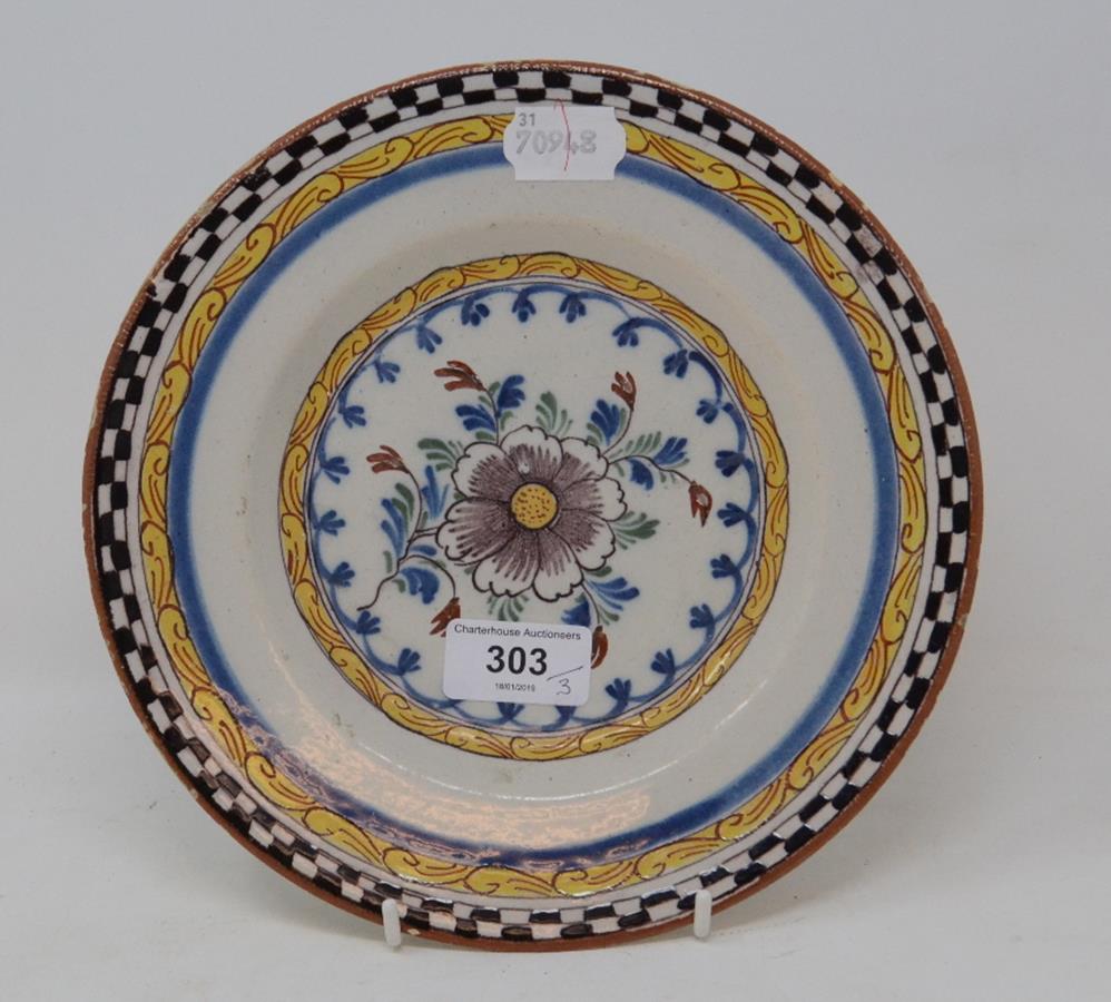 A set of three 19th century Dutch Delft polychrome plates, with floral decoration, 23 cm diameter