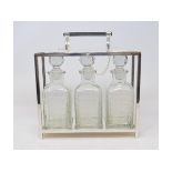 A Dr Christopher Dresser style three bottle tantalus, 27 cm high Modern Report by RH No the tantalus
