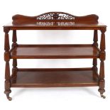 An early Victorian mahogany three tier buffet, on baluster reeded supports, 135 cm wide See