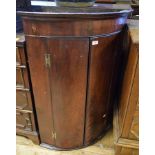 A George III mahogany bow front hanging corner cupboard, 75 cm wide