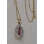 A 9ct gold, ruby and diamond pendant, on a 9ct gold chain Modern