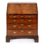 An 18th century bureau, veneered in walnut, the fall front revealing a fitted interior, above four