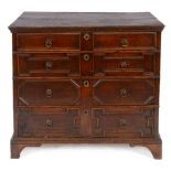 An 18th century oak chest, of four graduated long drawers, on bracket feet, 99 cm wide See