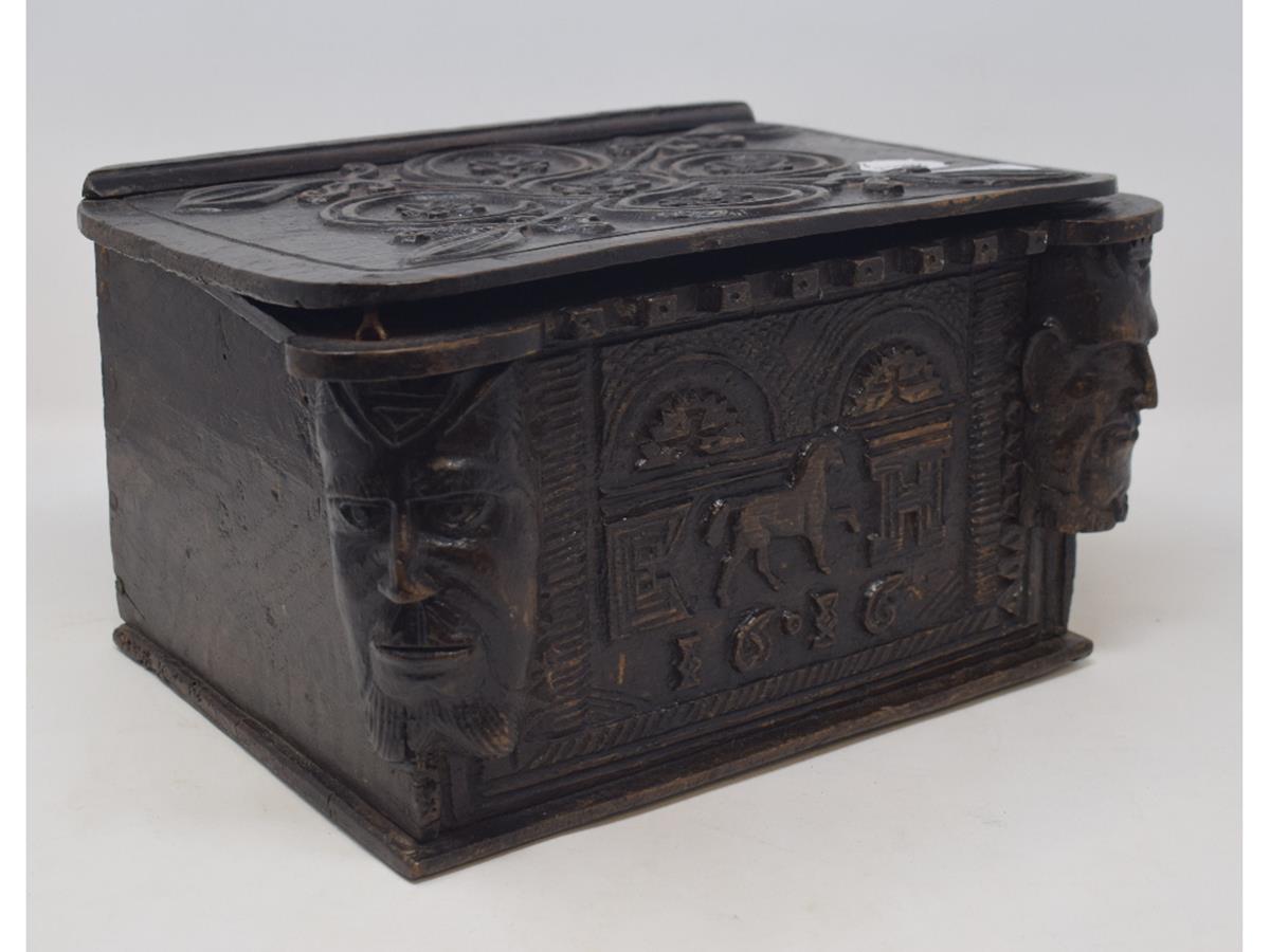 A carved oak bible box, of small proportions, decorated masks and bears date 1616, 30.5 cm wide