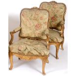 A pair of Louis XVI style carved giltwood fauteuil, with needlework tapestry backs, arms and