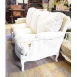A French three seater settee, with feather cushions and painted wood frame