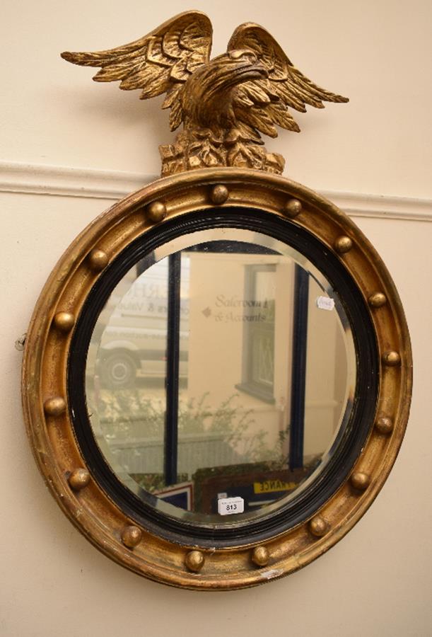A Regency style wall mirror, in a ball stud frame, surmounted an eagle, 84 cm high