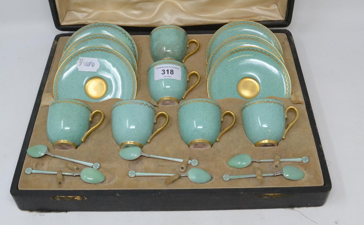 A Royal Worcester porcelain cabinet coffee set, with green glaze and gilt decoration and six
