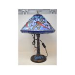A Tiffany style table lamp and shade, decorated dragonflies