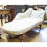 A Victorian walnut chaise longue, on turned legs
