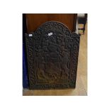 A Victorian cast iron fireback, having a coat of arms within a foliate border, 53 cm wide