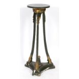 A Regency style jardiniere stand, with painted and gilt decoration, applied rams head masks, and