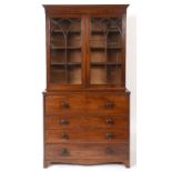 An early 19th century mahogany secretaire bookcase, the moulded cornice above a pair of lancelet bar
