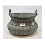 A cauldron, with hammered decoration, holed, 30 cm high (over handle)
