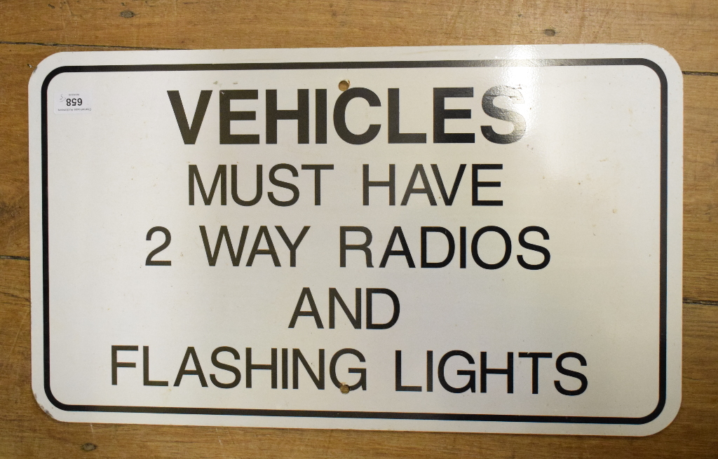 A tin information sign, 'Vehicles Must Have 2 Way Radio And Flashing Lights', 61 cm wide, and four