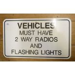 A tin information sign, 'Vehicles Must Have 2 Way Radio And Flashing Lights', 61 cm wide, and four