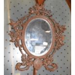 A late 19th century Black Forest style mirror, monogrammed, and carved birds, berries and leaves, 48
