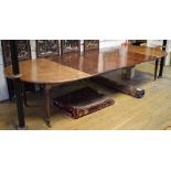 A mahogany extending dining table, the rounded rectangular top inset three extra leaves, on tapering