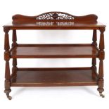 An early Victorian mahogany three tier buffet, on baluster reeded supports, 135 cm wide See