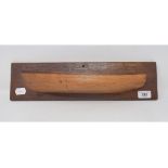 A ship's half hull, on an oak plinth, 43 cm wide