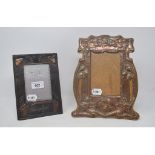 An Arts and Crafts copper photograph frame, Auld Lang Syne, 19.5 cm high, and another similar, 26 cm