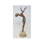 An Art Deco painted spelter figure of a dancer, the alabaster base applied a plaque West Bradford