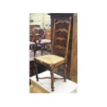 A fruitwood ladder back rush seat dining chair