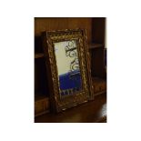 A gilt wall mirror, 55.5 cm high