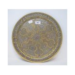 An Islamic brass tray, with copper and silver coloured metal inlay, 35.5 cm diameter