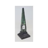 A stone obelisk, with painted decoration, 34 cm high