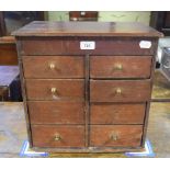 A table top miniature chest, of eight long drawers, 40 cm wide