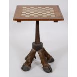An unusual chess table, with ivory inlay, on zebra legs, 54.5 cm wide See illustration
