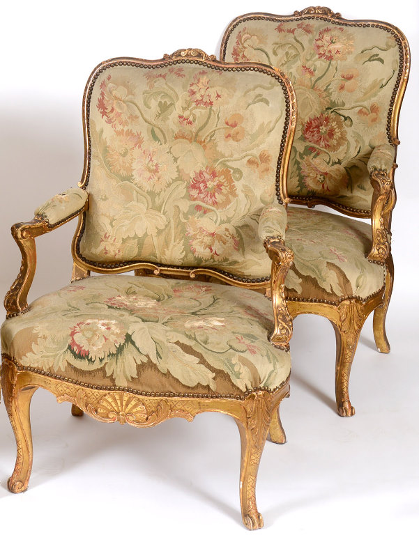 A pair of Louis XVI style carved giltwood fauteuil, with needlework tapestry backs, arms and