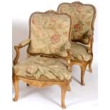 A pair of Louis XVI style carved giltwood fauteuil, with needlework tapestry backs, arms and