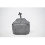An early 19th century lead oval tobacco box and cover, with figural finial, decorated swags and