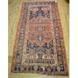A Persian rug, with geometric and other motifs on a dark blue ground, within a multi-border, 269 x
