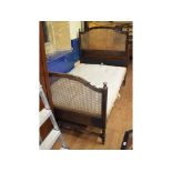 A Heal & Son mahogany bed, with cane work ends, with ivorine maker's plaque to headboard, 122 cm