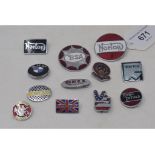 A collection of motorcycle lapel enamel and other badges for various marques, including Norton, BSA,