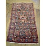 A Persian Nahavand carpet, with stylised floral decoration on a blue ground within a multi-border,