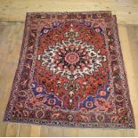 A Persian Bakhtiari rug, with a central medallion on a red ground, 207 x 165 cm