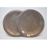 A pair of Islamic copper chargers, with silver coloured metal calligraphy and animal inlay, 35 cm