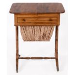 An early 19th century mahogany work table, having a sliding top above a false drawer, with a workbag