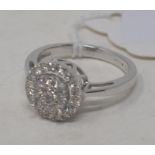 A 9ct white gold and diamond cluster, approx. ring size L½ Modern