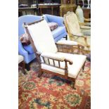 An early Victorian rosewood armchair, on tapering turned front legs