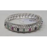 A silver, ruby, emerald and sapphire bangle Modern