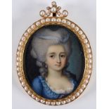 An oval bust portrait miniature, of a lady wearing a blue dress, watercolour, 4.5 x 3.5 cm, in a